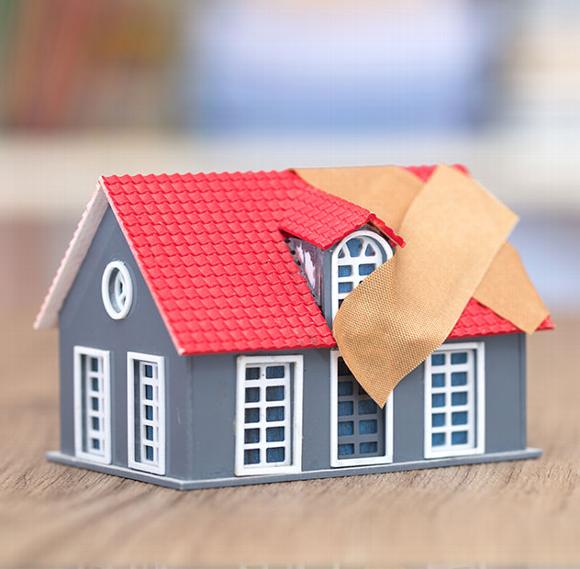 toy house with plaster crossed over the roof